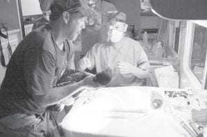 A common loon is prepared for surgery in July 2010. The bird was fitted with an internal satellite transmitter to track its migration patterns.