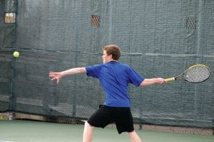 Above: Daniel Ahrendt returns serve against the doubles team of Duluth Central-Denfeld. Ahrendt, also an eighthgrader, teamed up with fellow eighth-grader Jamie Wick to win their match 6-4, 6-1.