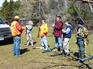 Dave Ingebrigtsen instructs students in safe gun handling in a simulated group hunting situation that includes loading, walking, crossing obstacles, and unloading.