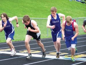 Above: When she’s not logrolling Jessica Berg-Collman shows she’s also a good runner. Collmann placed 6th in the 100- meter dash at the Barnum track meet to help her team win the meet. Right: Joey Chmelik (L), and Daniel Ahrendt (second from right), placed 5th and 6th in the 2-mile at the Barnum track meet. The boys finished 4th in the meet.