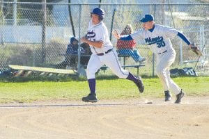 Right: Try as he might, the Albrook runner couldn’t elude the tag of Colin Everson. The Vikings have had to play a flurry of games in the past week to make up for games cancelled due to the cold, wet spring. The Vikings lost 3-4, but have shown flashes of good play and hopefully will be ready for the playoffs next week.