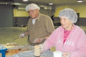 Chuck Soderholm and Mary McElevey filled plastic bags with the powdered food that will not only feed starving kids, but also will nourish them and help them grow strong and healthy.