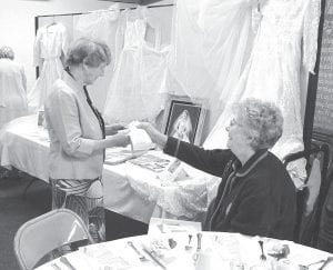 The theme of the spring brunch was weddings and a number of beautiful gowns were on display. Irene Malner shows Mary McElevey the receipt for her gorgeous wedding dress that she purchased from Oreck’s in Duluth. The price of the dress, which is satin and Chantilly lace, also included a wedding portrait from Power’s in Duluth.