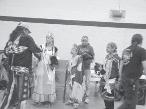 Grand Portage Royalty handed out gifts to community elders—Autumn Clearwater-Day, Samantha Scalise, and Jaden Aubid.