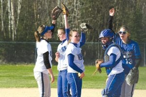 The Vikings get fired up before taking the field (L-R) Megan Lehto and CeCe Schnobrich touch gloves, while Kristina Rude, catcher Anna Carmen and Katie VanderHeiden, pointing to the sky, join in the party.