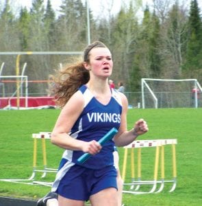 Above: Rachel Todd has had an outstanding track season for the Vikings. Here Todd runs a leg of the 4x100 relay, which finished 4th place at conference. Right: Adrianna Berglund shows off her sprinting form for the Vikings.