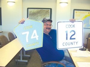 Highway Maintenance Supervisor Russell Klegstad showing the county’s two road sign options as old signs are replaced by highly reflective signs now required by the federal government. On May 24, 2011, the county board went with Klegstad and Highway Engineer David Betts’ choice of the five-sided blue sign.