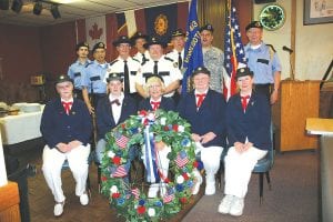 Joining forces to honor America’s fighting forces were Honor Guards from American Legion Post 413 of Grand Marais and American Legion Post 2009 of Grand Portage and the Post 413 Legion Auxiliary. Participating in the May 30 ceremony, which was moved indoors because of rain, were (L-R, seated) Edie Mattson, Kirsten Pederson, Eloise Christianson, Kathy Pederson, Nancy Leonard. (L-R, back) Joel Allard, Tony Swader, Orvis Lunke, Ron Wilson, James Ford, Commander Don Wilson, Mitchell Cyrette, Veterans Services Officer Clarence Everson.