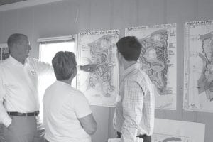 Brady Halverson (left) and Jaime Mehle of SEH consider the three concepts developed by the Grand Marais Park Board and other stakeholders. With them is Park Board Member Robin DuChien, who took part in the design charrette, which created the three preliminary designs for a Grand Marais Recreation Area “Community Connection”—a pedestrian friendly, welcoming entrance to the Rec Park and Grand Marais waterfront.