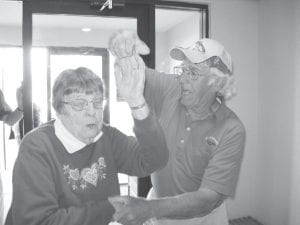 Taking a twirl on the dance floor with a friendly gentleman is Nona Smith.