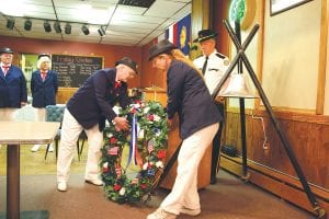 Although the Memorial Day ceremony was moved from the Cook County courthouse lawn to the American Legion Post 413 lounge, it was still a meaningful event. American Legion Ladies Auxiliary members Edie Mattson and Nancy Leonard set a memorial wreath in place. More about the Memorial Day ceremony on A3.