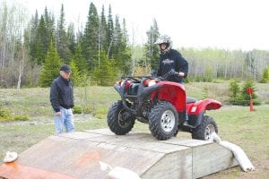 Minnesota Department of Natural Resources Youth ATV Safety Training was held May 18 and May 21. Students complete the course though CD at home and then have classroom review and a written test and then a field test. Owen Anderson practices riding on an incline under the watchful eyes of DNR volunteer instructor Dick Parker.