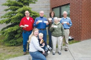 Some of the folks accepting checks from the Arrowhead Electric Operation RoundUp program at the Saturday, June 11 annual meeting were (L-R, front) Marja and Kaj Erickson for Cooperation Station Daycare and Biz Clark for the Cook County Coalition of Lake Associations. (L-R, back) Jesse Derscheid for Hovland Fire Department; Fred Smith for the Gunflint Trail Historical Society and Gunflint Trail Scenic Byways; Barb Bottger for Gunflint Trail Fire Department and the Banadad Trail Association and John Bottger for the North Shore Dragon Boat Festival.