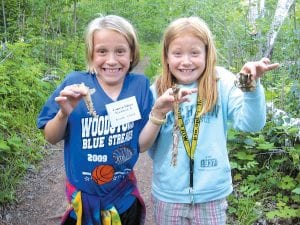 You never know what you’ll find on a walk in the woods! These young ladies, on a nature hike at Wolf Ridge Environmental Learning Center study deer bones.