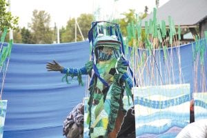 A highlight of the Wooden Boat Show is the Summer Solstice Pageant. This year’s production on Saturday evening, June 18 was Never Mine-d. Colorful costumes are the order of the day, such as this verdant green patchwork frog queen, who awakened the bog.