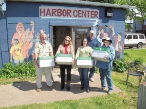 The Cook County Visitors Bureau was happy to take over the Outdoor Classroom Program formerly operated by the non-profit Harbor Friends. Moving the materials on June 14 were (L-R) Jerry Hiniker of Harbor Friends, CCVB Administrative Assistant Anna Klobuchar, CCVB Executive Director Sally Nankivell, Ken Hoffman (behind) and Molly Hoffman of Harbor Friends.