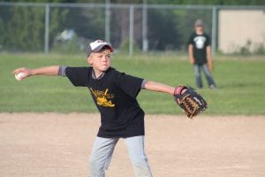 Ethan Sporn shows great concentration as he goes into his wind-up in a recent Little League game.