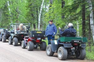 The Cook County ATV Club Kick-Off Party on Saturday, June 18 had about 50 people in attendance. Members enjoyed a free burger or brat, played games, and visited at the Cook County RidgeRider’s groomer building on the Meridian Road in Grand Marais. Daniel Lashinski of Grand Marais won the grand prize—a 22-inch plasma TV. The ATV Club board said thanks to Buck’s Radio Shack for the deep discount on the TV. Members who joined the ride enjoyed 27 miles of scenic Cook County back roads. Left: Charlie Tice pulls over to take a break. Above: Chuck Bolinger of Hovland and Charlie Tice visit at another stop—while four-wheeling Golden Lab Ripper patiently waits to get going again!