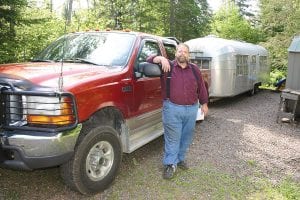 Professional hauler Robert Houghton made his way from Washington State to Andrew Herman and Jane Powers’ secluded property in Lutsen to pick up the 1956 Sovereign of the Road Airstream they recently sold. Houghton towed the vintage trailer to the Port of Baltimore, where it was shipped to England. Airstream dealer and restorer Sam Harkness, who bought the trailer, has been negotiating a deal with another potential buyer.