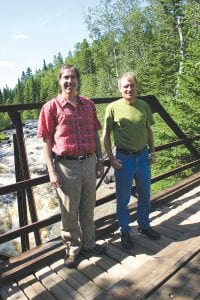 Lutsen Mountains co-owners Tom Rider (left) and Charles Skinner on the bridge over the waterfall 2.6 miles from the river’s mouth.