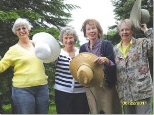 Taking their hats off to flowers are the Grand Marais Garden Club Flower Show planning committee members, (L-R) Nancy Strayer, Skip Joynes, Anne Penny, and Emma Bradley.