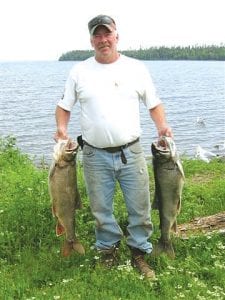 Einer Lockwood of Grand Marais holding a couple nice lake trout caught in Lake Superior on June 26.