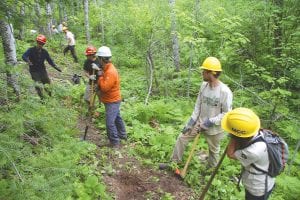 Order of the Arrow Scouts and Minnesota Conservation Corps members working on the single-track mountain bike trail at Pincushion Mountain. Scouts cleared nearly two miles of trail.