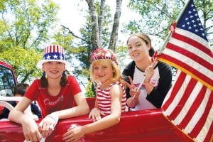 Hurray for the red, white and blue! Showing their spirit of independence in the July 4, 2011 parade in Tofte were (L-R) Isabelle Pechan of Little Falls, MN, Gracen Roehrs of California, and Kendra Shoemaker of Rosemount, MN. See more Cook County 4th of July celebrations on page A3.