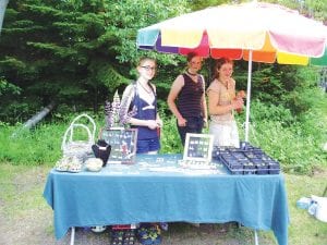 The Hovland Arts Festival once again fulfilled its mission to have folks “Get Hooked on Art” at the July 2 – 3 event. There was an amazing array of artwork and whimsical offerings—such as a pair of Crocs filled with Hen and Chick plants. The funky shoe-planter and other plants, as well as some lovely jewelry, was available at Aubrey Lewis’s booth. Hanging out with Aubrey are Cedar and Meadow Adams.