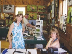 Author Jenyfer Matthews (left) was at the Arts Festival with her books, also enjoying time with her dad and stepmom, Bruce and Sandy Updyke of Hovland, (right) who are regulars at the Arts Festival with Sandy’s beautiful photography and Bruce’s wonderful woodwork.