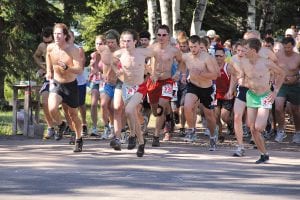 And they’re off! The runners take off for the 33rd Tofte Trek 10K Wilderness Run. Jockeying for position at the front are three top finishers—3rd place finisher Wayne Kerr of Duluth in front on the far left. Front and center in the middle, in bib 212 is Guthrie Cunningham of Finland, MN who finished 2nd. And first place finisher Matt Volz of Minneapolis is on the far right, bib 338. Volz vanquished the Tofte Trek in 0:38:24.4, a remarkable pace of 06:10 on the muddy trail.