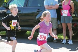 Annie Lynch, 8, of Grand Marais, was the winner of the kids’ one-mile race. She faced a challenge at the finish from the young man wearing bib No. 625. Annie kicked it in gear and held onto the win.