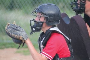 Above: With eyes focused and glove ready, Twins catcher Colton Furlong is ready to receive the ball from the pitcher.