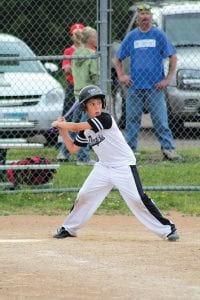 Left: Right before he hit the ball a country mile, Josh Prom brought his bat back and unleashed a mighty swing. Despite some mighty fine fielding and hitting by the Dodgers, they lost to the Twins.