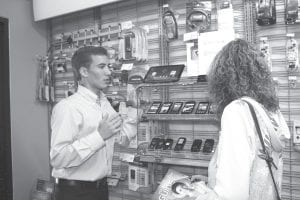 On July 13, the first “Tech Squad” session was held at Buck’s Radio Shack in Grand Marais. Students in the program—a collaboration among Cook County Higher Ed, the Northland Foundation, and Radio Shack—spent the day talking technology with customers. Tech Squad member Luke Fenwick talks to Nicole Boostrom about different cell phone options.