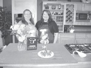 Paulette Anholm of Grand Marais, making wonderful Sticky Rhubarb Muffins. Pictured with her is show host Juli Kellner.