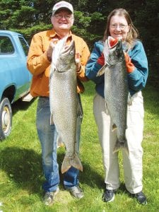 Left: Lake Superior was good to the Ford family on July 14. Steve reeled in this monster 22-pound lake trout and Cheryl caught a 13-pounder. After a great day on the lake, the family enjoyed barbecuing the fresh lake trout.