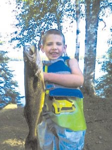 Braidy Smith of Grand Marais shows off the very nice walleye he caught on Devil’s Track Lake on July 3. Braidy’s catch was 19 inches long.