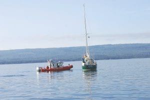 The U.S. Coast Guard boat from the Grand Marais Station talks to the captain of the Loon about the mechanical difficulties the sailing vessel was having on Saturday, July 30. The Coast Guard towed the stranded ship into the Grand Marais harbor.