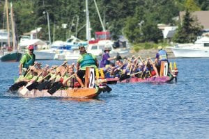 With the drummer sounding rhythm and steersperson David Seaton shouting encouragement, the Hungry Jack Outfitters team pulls ahead of the Northern Lights Timber Framing team in the North Shore Dragon Boat Festival on Saturday, July 30. The Grand Marais harbor was full of the sights and sounds of the dragon boat festival last weekend. See more photos and race results on page A3.