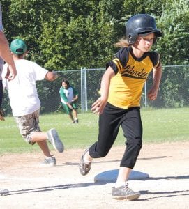 Abby Crawford of the Yankees rounds third base and digs in for home as Joe Deshampe makes a throw into the infield. The Yankees won this year’s Parent Pitch championship.