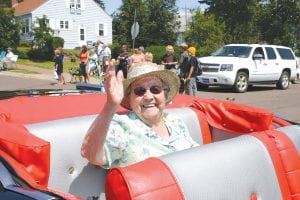 Above: Iola Wojtysiak of Grand Marais was a bit embarrassed by all the fuss at the beginning of the parade, but the Senior Citizen of the Year perfected her wave by the end of the day.