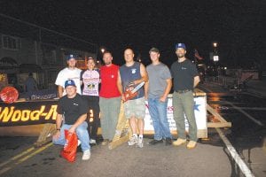 There were 32 competitors in the Friday, August 5 stock chainsaw contest. Finishing in the money were (L-R) Chris Serpico, 10th (front), Carl Rick 7th, Jenny Atkinson 8th, Jeff Eliasen 4th, Aaron Mielke, 1st with his new Husqvarna chainsaw, Clay Johnson 2nd, and Erik Simula, 3rd. Right: Aaron Mielke cutting through 20” lathe-turned white pine with Husqvarna’s 373XP during the professional sawyers competition.