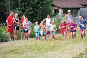 The North Shore Ski and Run Club hosted its Fisherman’s Picnic Trail Run on the Pincushion Mountain Trails overlooking Grand Marais on a hot and muggy Saturday, August 6. The warm weather did not seem to bother the 120-plus runners—many of them were seen later in the day at other Fisherman’s Picnic events, sporting their bright red Trail Run T-shirts. Before the 