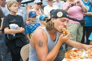 There was more food fun at Sven & Ole’s Pizza. Above left: Contestants in the pizza-eating contest attempted to devour a 12-inch thick-crust pizza as fast as possible. The winner, who finished off his pizza in a laid-back manner, was Fathom Kidd of Duluth. He finished the entire pizza in just 4 minutes 18 seconds. Above right: The Pickled Herring Eating contest was almost over before photos could capture the moment and Anthony Czeck of Hauula, Hawaii and Lino Lakes, MN was the winner, polishing off an order of pickled fish in just 38 seconds.