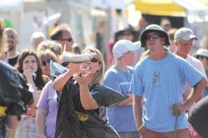 Like other years, the Grand Marais Lions Club Fish Toss included a bit of comedy as errant throws flipped slimy fish into the crowd. One fish seriously overthrown by competitor Lars Scannell ended up on the roof of the Blue Water Café—a happy turn of events for seagulls in the vicinity. Julie Carlson of Grand Marais has been a past winner of the Fish Toss Contest, claiming the women’s title with her friend Lisa Rambol in 2006. This year Julie teamed up with Shanie Hahn of Duluth, pictured here bravely going for the glory. The women took the 2011 Women’s Fish Toss title!