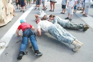 Specialist Austin Turner told climbers, “If you don’t make it to the top, you have to do five push-ups.” With a grin, Turner added, “If you do make it to the top, you get to do five victory push-ups!” The Guard Members happily joined in with kids like Adrian Howard-Larsen who took the challenge again and again.