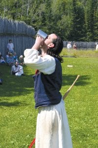 Camp Booshway Stephan Veit demonstrates how the competitors in the Rugged Voyageur should sample the “high wine” in the Rugged Voyageur contest. High wine is actually not wine, but a distillate containing a very high percentage of alcohol. In the Rugged Voyageur Contest, it is just water.