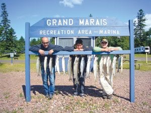 A great day on the Big Lake! (L-R) Gunflint Lake cabin owners John, Mike, and Sam Pugh with their August 10 catch. They were fishing with Captain Jerry Skarupa aboard the charter boat Secret Lures.