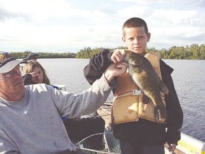 Above: Brady Gadient, 9, of Goodhue, Minnesota holds a 17.5-inch smallmouth that he caught on a jig and a leech while fishing with Joe Carlson (left) of Joe’s Inland Fishing Guide Service last week. Left: Proud angler Brenna Bloomer, 16, of Eagan, Minnesota shows off her catch—22-inch, 18-inch and 16-inch walleyes, a 24-inch northern and a smallmouth just under 12 inches. Brenna was fishing with Joe Carlson of Joe’s Inland Fishing Guide Service.